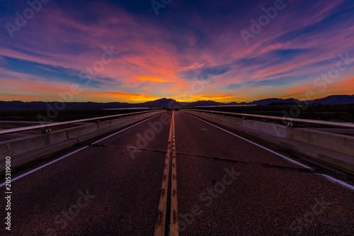 MARCH 12, 2017, LAS VEGAS, NV - Highway overpass above Interstate 15, south of Las Vegas, Nevada at sunset with yellowline