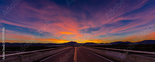MARCH 12, 2017, LAS VEGAS, NV - Highway overpass above Interstate 15, south of Las Vegas, Nevada at sunset with yellowline