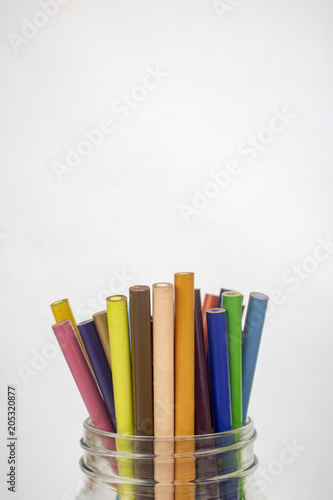 A jar of colored pencils on an isolated white background with room for text 