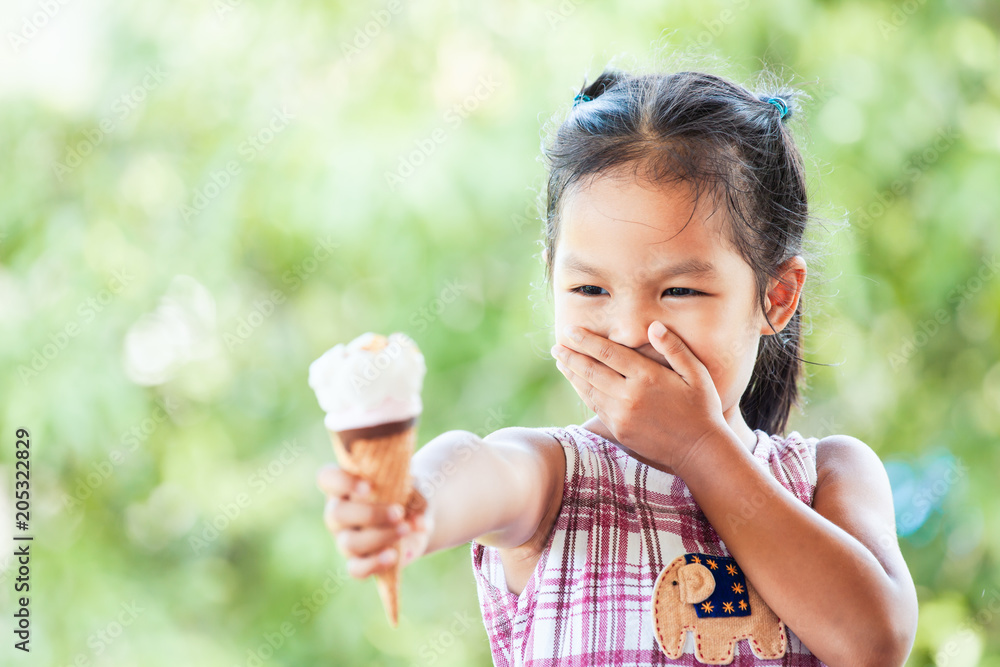 Cute asian little child girl don't like icecream cone Cute asian little child girl don't like icecream cone