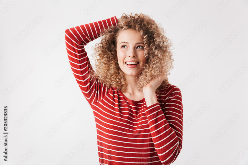 Playful curly woman in casual clothes posing and looking away Playful curly woman in casual clothes posing and looking away