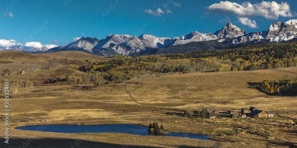 Historic Last Dollar Ranch owned by Rod Lewis nestled under view of Mount Sneffels and San Juan Mountains in Autumn