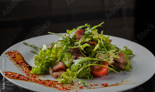 Vegetable salad on a plate on a glass background