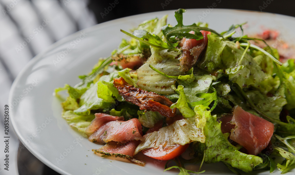Vegetable salad on a plate on a glass background Vegetable salad on a plate on a glass background