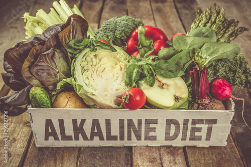 Foto Alkaline diet concept - fresh foods on rustic background