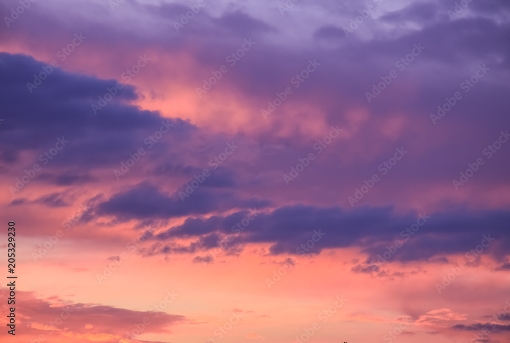 romantic sunset with clouds as background