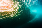 Underwater barrel wave in tropical sea in Oahu. Water texture in ocean with sunset light