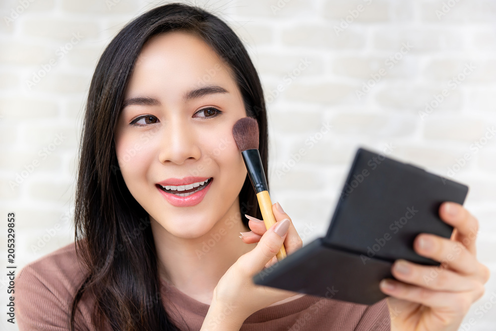 Beautiful Asian woman beauty blogger doing a make up tutorial Beautiful Asian woman beauty blogger doing a make up tutorial
