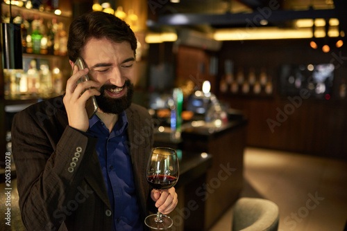 Cheerful man spending evening in ber