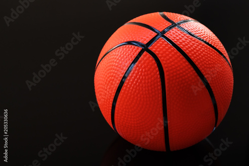 Basketball on a black background as a sports and fitness activity © PORNCHAI SODA