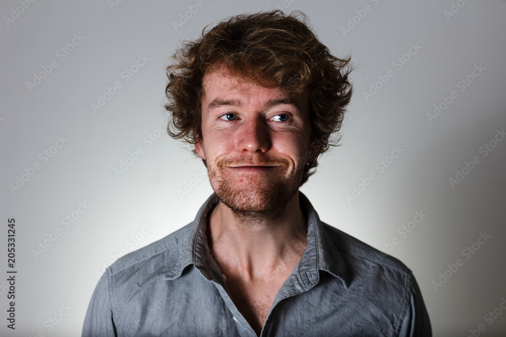 Young male smiling with dirty expression Young male smiling with dirty expression