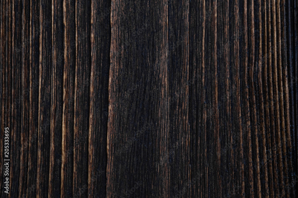 Close up of dark brown wood texture with natural striped pattern background Close up of dark brown wood texture with natural striped pattern background