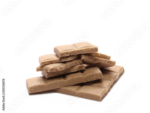 White nougat chocolate bar pieces with hazelnuts isolated on white background