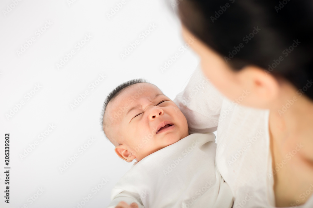 Mother trying to comfort her crying baby isolated Mother trying to comfort her crying baby isolated