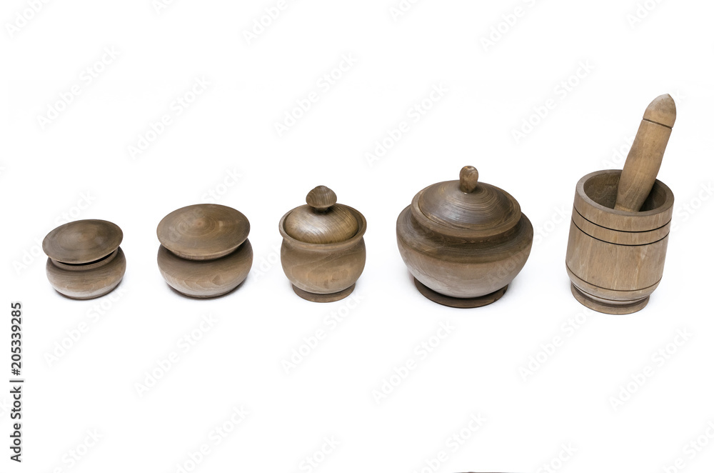 Wooden kitchen pots and mortar with pestel isolated on white background. Kitchenware. Kitchen utencils. Wooden kitchen pots and mortar with pestel isolated on white background. Kitchenware. Kitchen utencils.