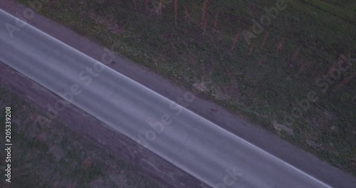 aerial view of landscape with a ride on the highway trucks and a few cars at sunset. 4K photo