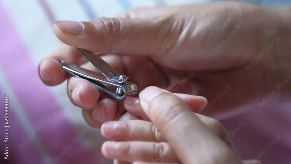 Cut fingernails. Cutting nails to a newborn baby a little mother care. Cut fingernails. Cutting nails to a newborn baby a little mother care.