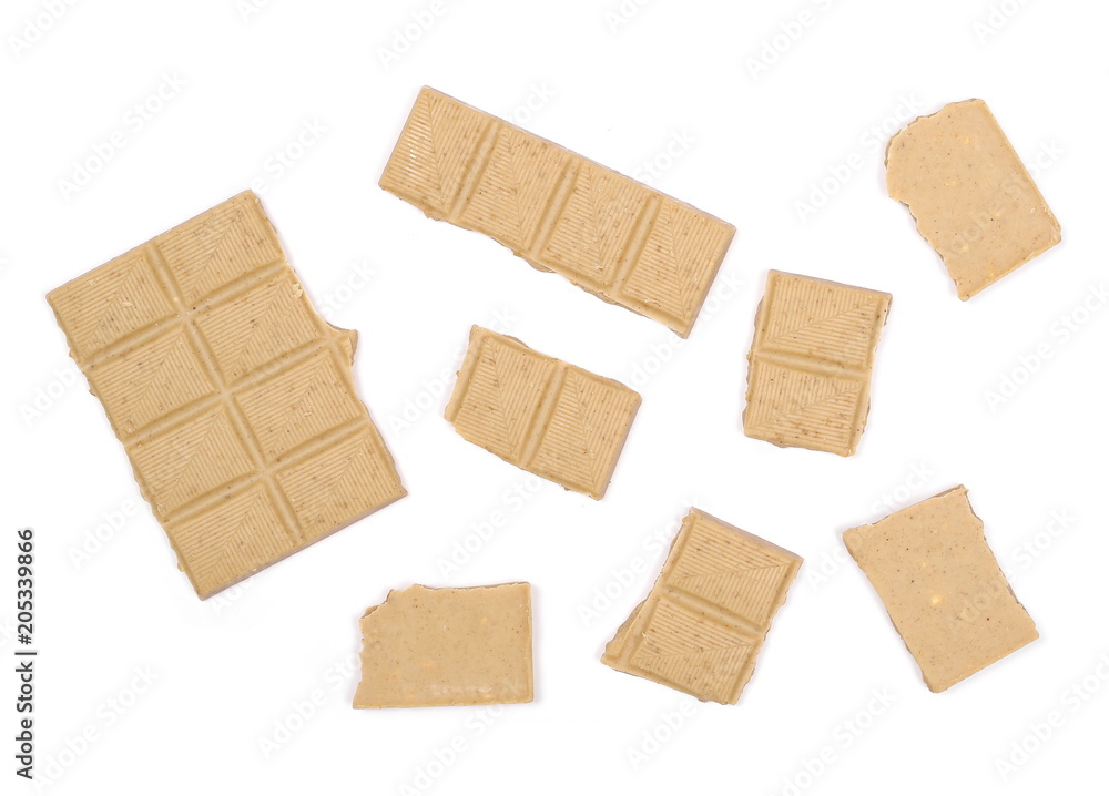 White nougat chocolate bar pieces with hazelnuts isolated on white background, top view White nougat chocolate bar pieces with hazelnuts isolated on white background, top view