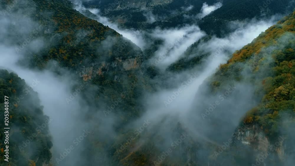 Aerial flight inside cloudy foggy high mountains canyon Aerial flight inside cloudy foggy high mountains canyon