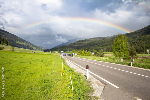 Rainbow above road and mountains