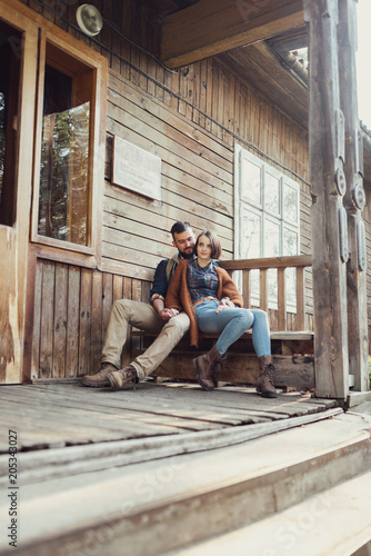 young couple hipster sitting on a bench on the terrace