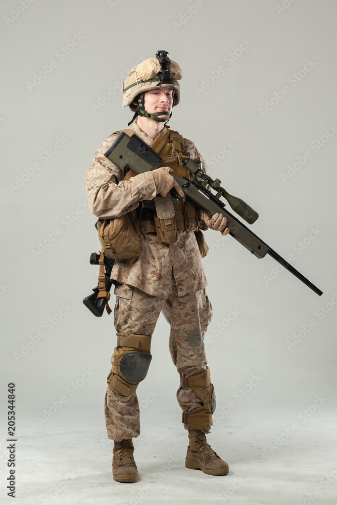 Soldier in camouflage holding rifle Soldier in camouflage holding rifle