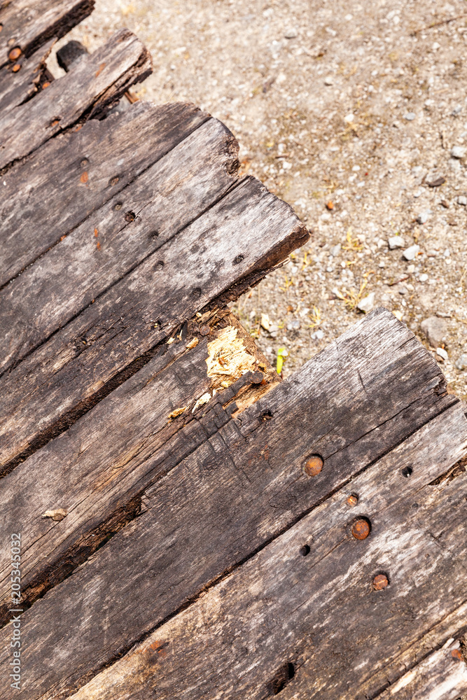 Close-up view of the broken planks of wood on the trolly, in Cromford mill, Derbyshire, England. Close-up view of the broken planks of wood on the trolly, in Cromford mill, Derbyshire, England.