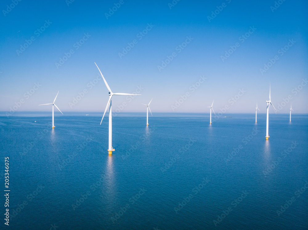 drone view at an windmill farm at sea - obrazy, fototapety, plakaty 