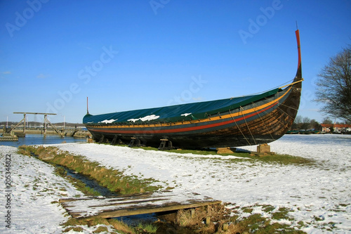 Wooden replica of Viking longship stranded during winter. photo