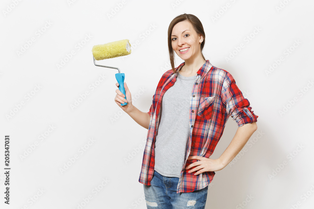 Young smiling beautiful woman in casual clothes holding paint roller for wall painting isolated on white background. Instruments, accessories, tools for renovation apartment room. Repair home concept. Young smiling beautiful woman in casual clothes holding paint roller for wall painting isolated on white background. Instruments, accessories, tools for renovation apartment room. Repair home concept.