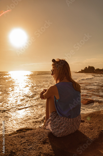 Girl enjoying sea / ocean scenery in Bali, Indonesia.