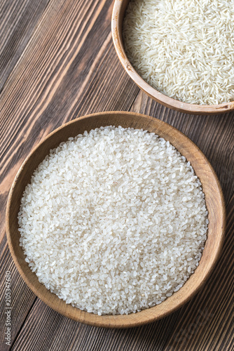 Bowls of uncooked camolino and basmati rice photo