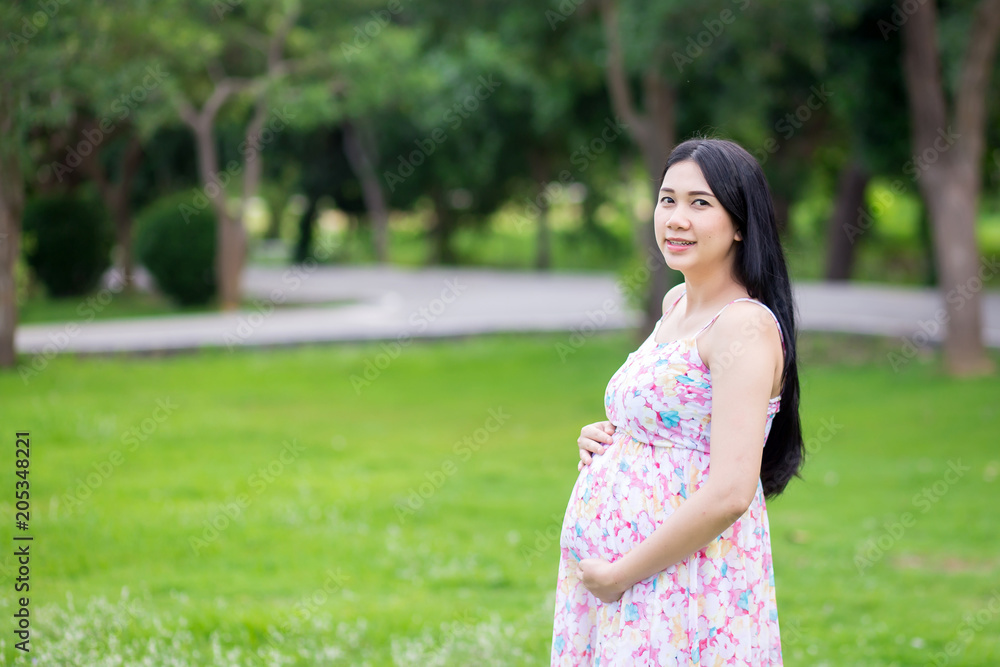 Beautiful pregnant woman relaxing outside in the park Beautiful pregnant woman relaxing outside in the park