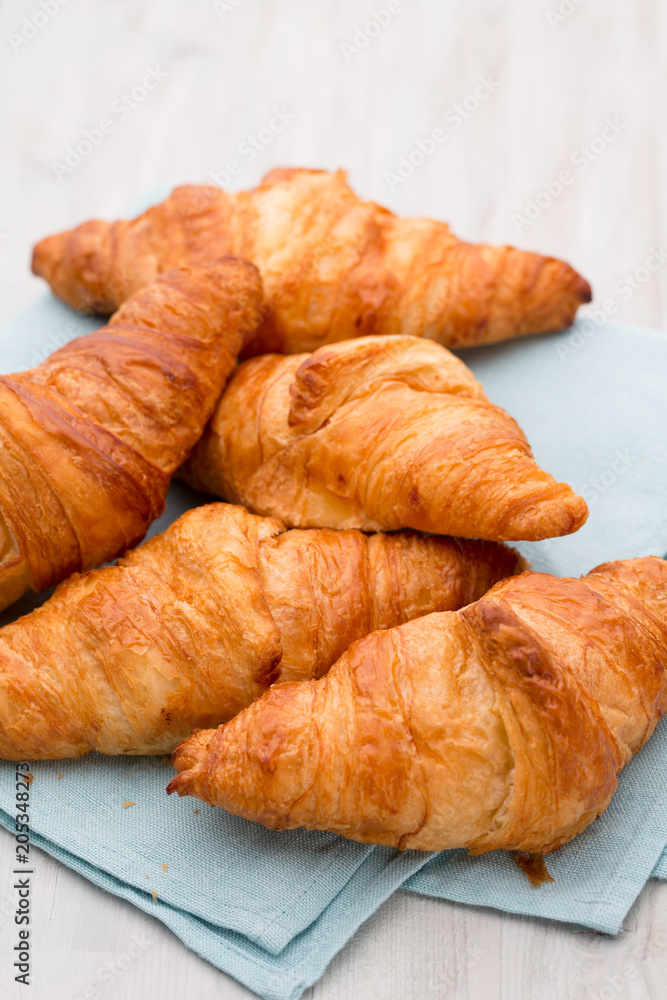 Tasty buttery croissants on old wooden table. Tasty buttery croissants on old wooden table.