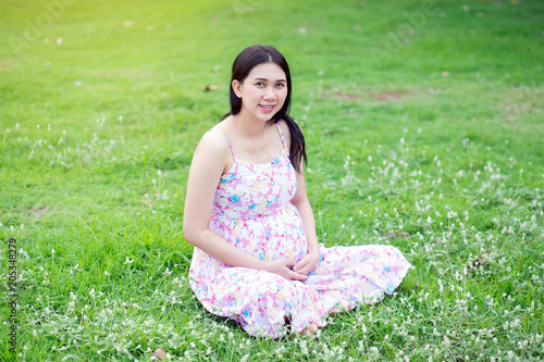 Beautiful pregnant woman relaxing outside in the park © aot