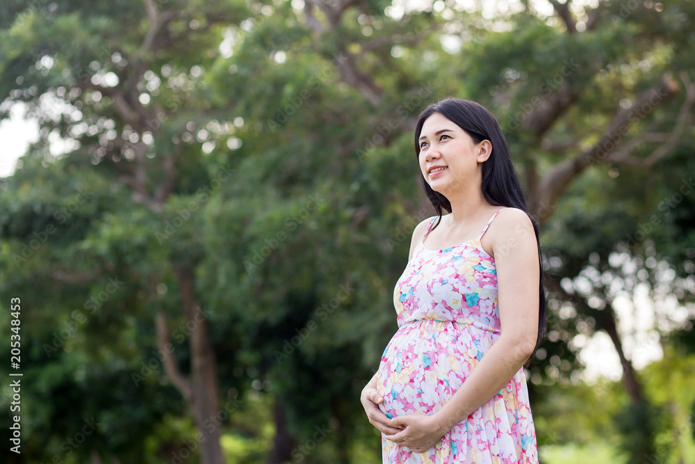 pregnant woman relaxing in the park pregnant woman relaxing in the park