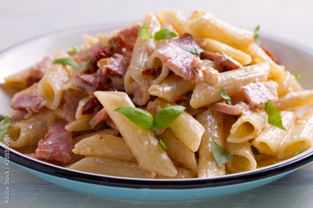 Penne pasta with bacon and sundried tomatoes