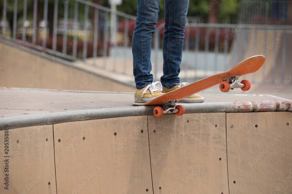 Skateboarder on skatepark ramp Skateboarder on skatepark ramp