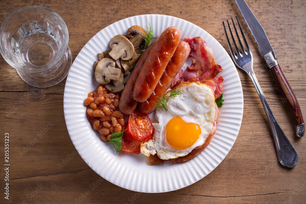 Full English or Irish breakfast on wooden table. Nutritious and healthy morning meal. Overhead, horizontal Full English or Irish breakfast on wooden table. Nutritious and healthy morning meal. Overhead, horizontal