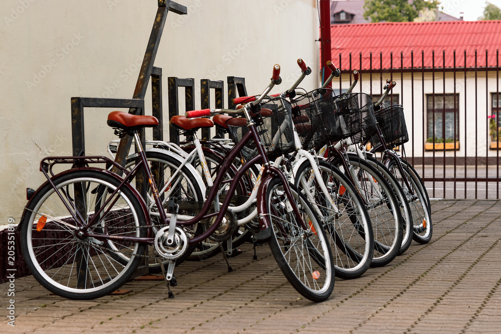 city bicycles for rent stand in a row on a cobbled street of Copenhagen, Denmark