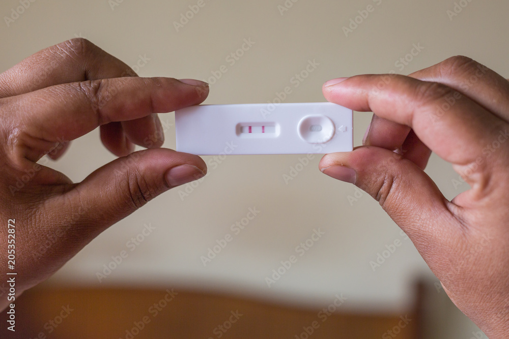 Close up of Pregnancy Tester with Hand Close up of Pregnancy Tester with Hand
