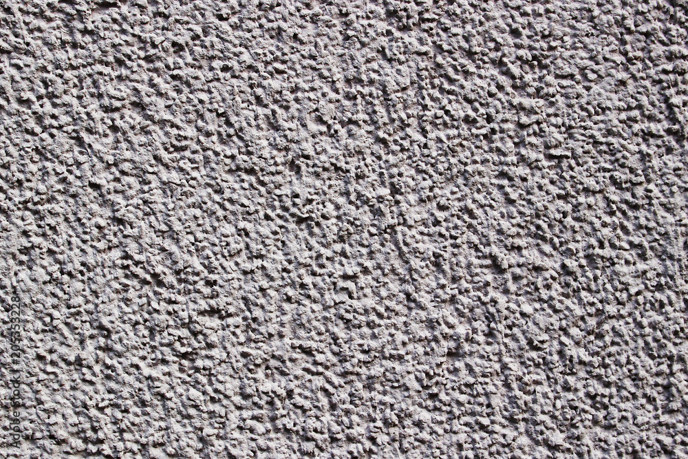 A light lilac grey painted stone wall as texture of a background
A light lilac grey painted stone wall as texture of a background