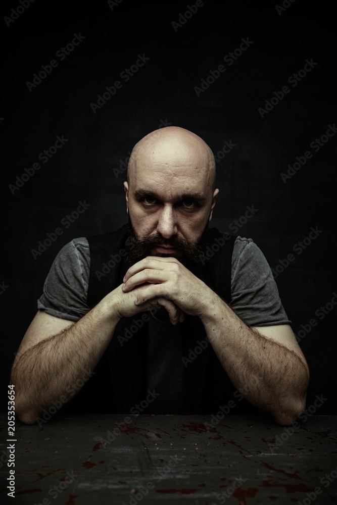 portrait of pensive young bearded man looking at camera portrait of pensive young bearded man looking at camera
