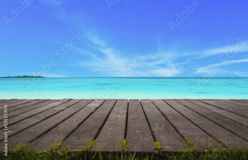 Fototapeta Naklejka Na Ścianę i Meble -  Blur cool sea background with foreground wood floor.