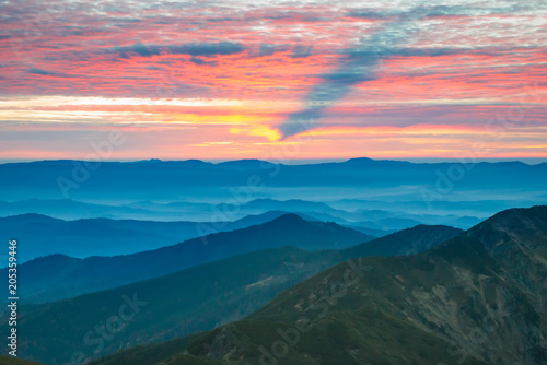Beautiful landscape with sunset in blue mountains © Pavlo Vakhrushev