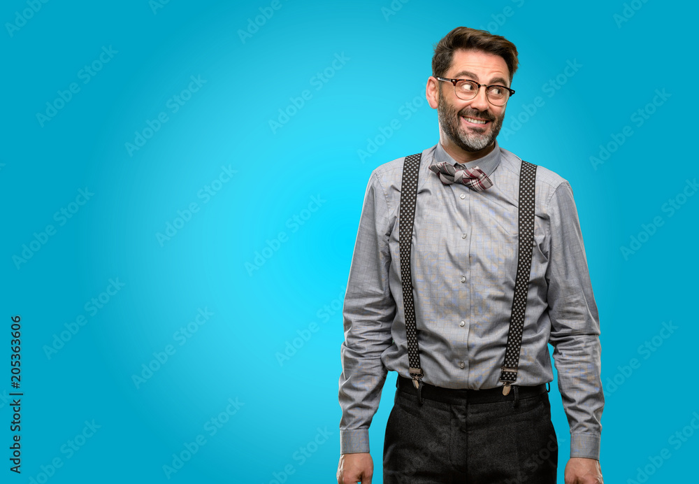 Middle age man, with beard and bow tie confident and happy with a big natural smile laughing Middle age man, with beard and bow tie confident and happy with a big natural smile laughing