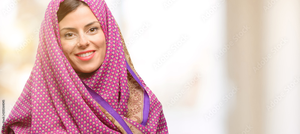 Young arab woman wearing hijab confident and happy with a big natural smile laughing Young arab woman wearing hijab confident and happy with a big natural smile laughing