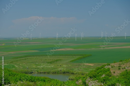 Field with wind turbines to produce green energy