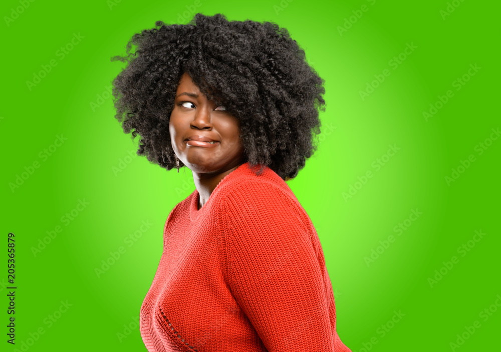 Beautiful african woman feeling disgusted with tongue out Beautiful african woman feeling disgusted with tongue out