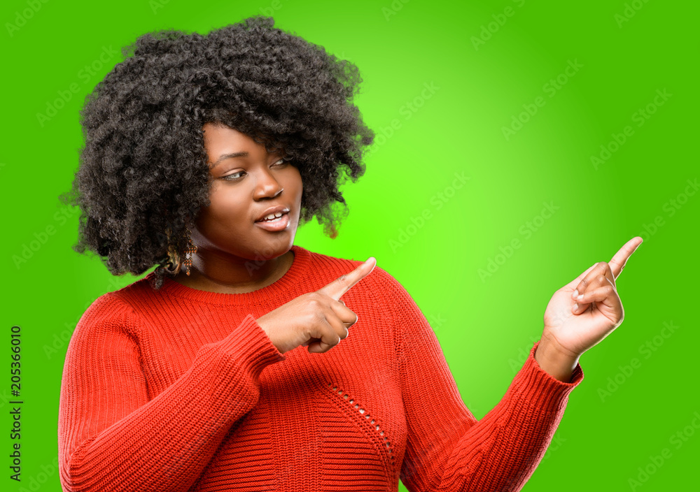Beautiful african woman pointing away side with fingers Beautiful african woman pointing away side with fingers